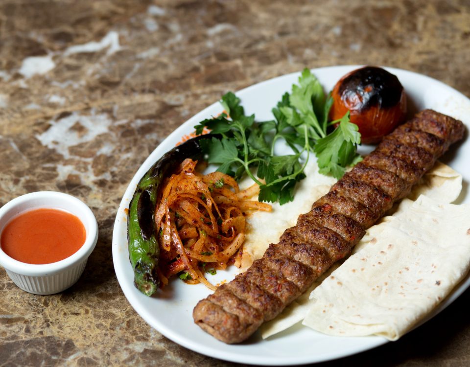 adana-kebab-served-with-flatbread-grilled-pepper-tomato-caramelized-onion